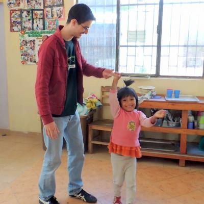 Early Childhood Development volunteer dancing with a child at his placement Projects Abroad Early Childhood Development volunteer dancing with a child during his spring break project placement